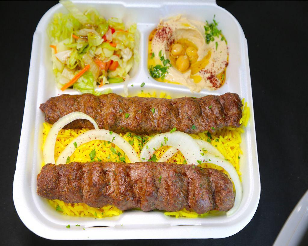 Kefta Kabob plate · 2 skewers of grilled ground Beef & Lamb marinated for a perfect taste served with rice, salad, pita bread, and hummus