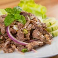 25. Num Tok Salad (Beef) · Grilled steak, chili, lime juice, green onion, mint, cilantro and red onion combined with an...