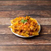 Super Nachos · Chips, beans, cheddar cheese, sour cream, onions, tomatoes and guacamole.