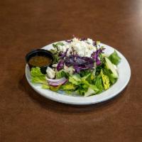 Side Greek Salad · Fresh romaine lettuce sprinkled with feta cheese, Kalamata olives, garden vegetables and Rus...