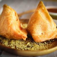 2 Pieces Samosa · Pastry triangles with savoury potatoes and peas. Vegan.