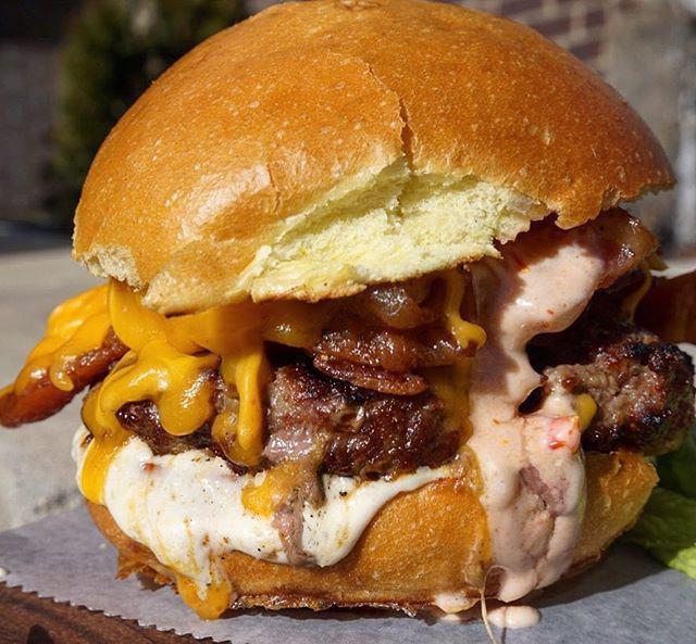 Dbar Deluxe Burger · Cheddar, Applewood smoked bacon, roasted tomato mayo, horseradish aioli and brioche.