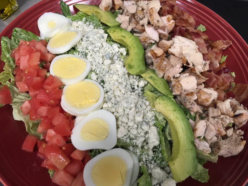 Cobb Salad · Tomatoes, roasted North Fork sweet corn, avocado, grilled chicken, olives, bleu cheese, smoked bacon, egg and basil balsamic vinaigrette.