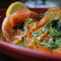 Shrimp Scampi · House spinach fettuccine, scallion, Shrimp and tomato and white wine/ butter sauce.