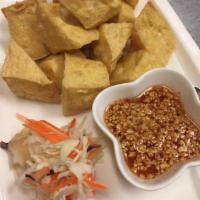 6. Fried Tofu · Golden-fried tofu served with tangy sweet sour sauce and sprinkled with crushed peanut.
