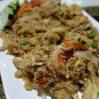 39. Pineapple Fried Rice · Thai fried rice with eggs, chicken, shrimp, onion, carrot, cashew nuts, peas, pineapple and ...