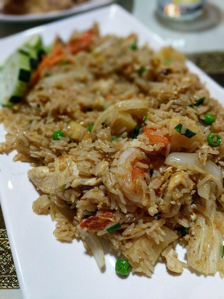 39. Pineapple Fried Rice · Thai fried rice with eggs, chicken, shrimp, onion, carrot, cashew nuts, peas, pineapple and green onion.