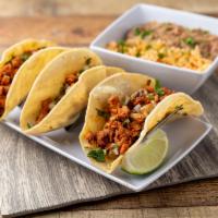 Tacos Pastor · Los mas populares de Mexico. 3 soft corn tortilla with marinate pork, rice and beans, cilant...