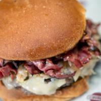Reuben Burger · Hot pastrami, Swiss cheese, sauerkraut, Russian dressing, and pickles on a deli bun.