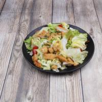 Crispy Chicken Salad · A romaine and iceberg mix with diced red onions, tomatoes, chopped breaded chicken breast, c...