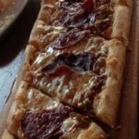 Karisik Pide · Turkish special pizza with soujouk, pastrami and kasseri cheese.