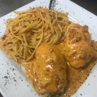 Chicken Rollatini · 2 chicken brest stuffed with spinach and cheese in signature pink vodka sauce over pasta.