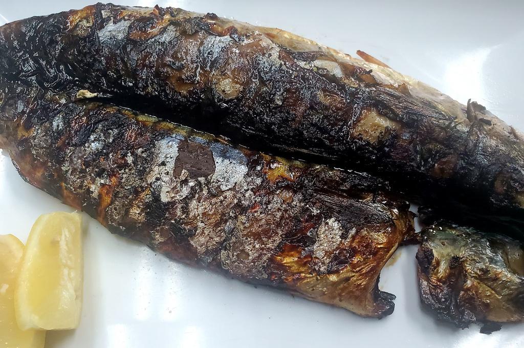 Go Dung U Gui · Lightly salted and grilled mackerel fish.