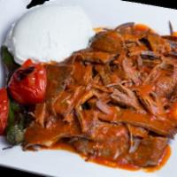 Iskender Kebab · Sliced lamb and beef gyro, fried cut pita bread, butter, tomato sauce, and yogurt on the side.