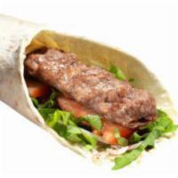 Adana (Long kofteh) Wrap · Ground lamb and beef meat, tomatoes, lettuce, onions. Served with potato wedges and white sa...
