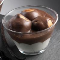 Profiteroles · Layer of vanilla cream topped with cream puffs covered in chocolate sauce. (3pcs)