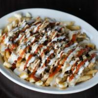 Shawarma Fries ·  Doner style lamb on a bed of curly fries. It also comes dripping with garlic & hot sauce. 