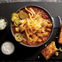 Firehouse Beef Chili · Topped with sharp cheddar cheese and served with grilled jalapeño cornbread, red onions, fre...