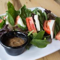 Caprese Salad · Fresh mozzarella, basil and tomatoes over mixed greens with a side of house made balsamic dr...
