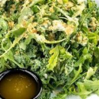 Kale Arugula Salad · Kale, arugula, toasted breadcrumbs, Parmesan cheese and honey lemon dressing.