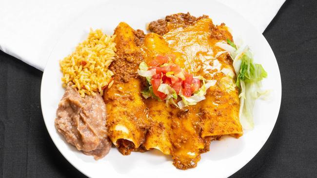 Beef Enchiladas · Corn tortillas filled with ground beef, topped with chili con carne and cheese. All served with Spanish rice, borracho beans and fresh homemade flour tortillas.