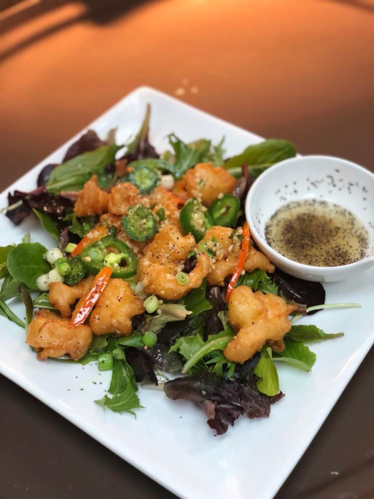 Lemon Pepper · Lightly battered and tossed with jalapenos and garlic, served on a bed of spring mix and a side of lemon pepper sauce.