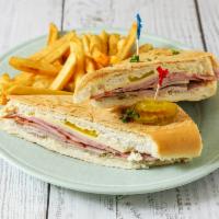Cuban sandwich · Cuban Sandwich toasted with butter panini style with sliced ham, pork, Swiss cheese, & Pickl...