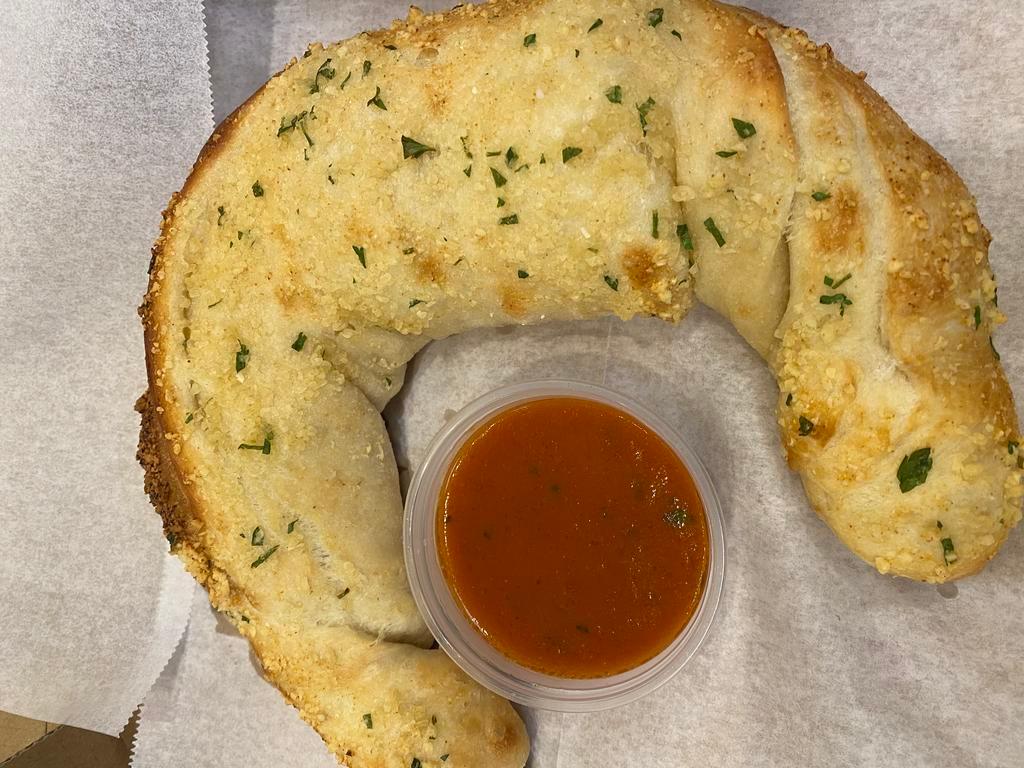 Vegan Mozzarella Stuffed Garlic Bread · Vegan butter, garlic and herbs spread on our house made dough stuffed with 
Vegan Mozzarella served with marinara sauce for dipping...Decadent