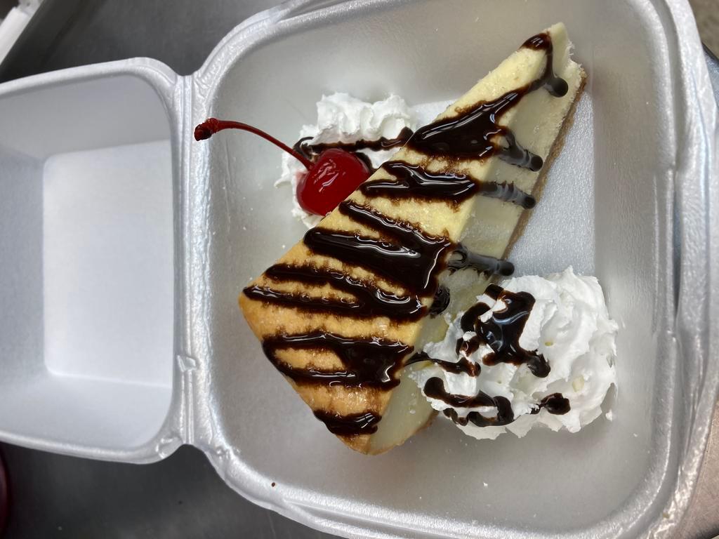 Cheesecake · New York Cheesecake drizzled with chocolate, whipped cream & cherry