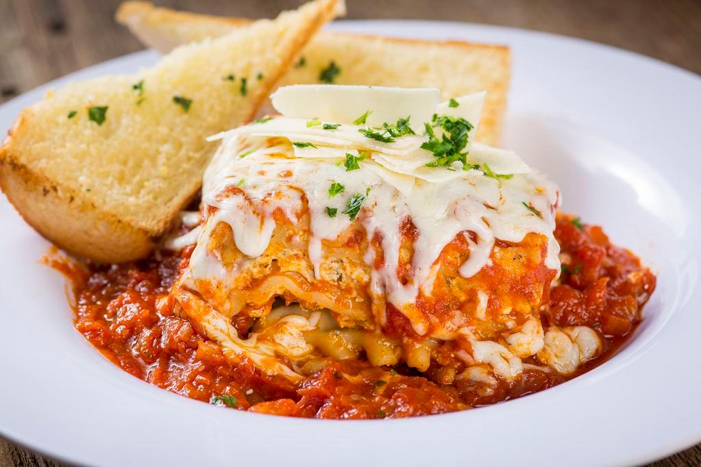 Lasagna · Homemade from the family recipe: layers of ribbon noodles and 3 cheeses, smothered in marinara sauce, topped with baked mozzarella cheese, and fresh parsley.
