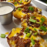 Potato Skins · Filled with bacon bits, mozzarella cheese, topped with green onions and served with ranch dr...