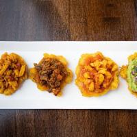 Tostones Noches · Smashed fried plantain topped with guacamole, shrimp, steak and chicken.