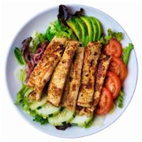 Ensalada de Pollo · Grilled chicken salad with layers of lettuce, tomatoes, cucumbers, onions & avocado.