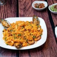Paella Noches · Our delicious version of paella with Colombian chorizo, calamari and shrimp.