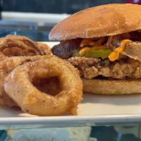 SPICY CHICKEN SANDWICH  · Spicy Dora sauce, pickles, onion rings and our house made spicy chicken! 