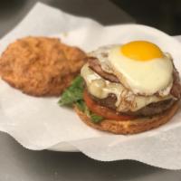 Ale's Burger · Lettuce, tomato, ham, bacon, egg and Swiss cheese nestled between our homemade brioche buns.