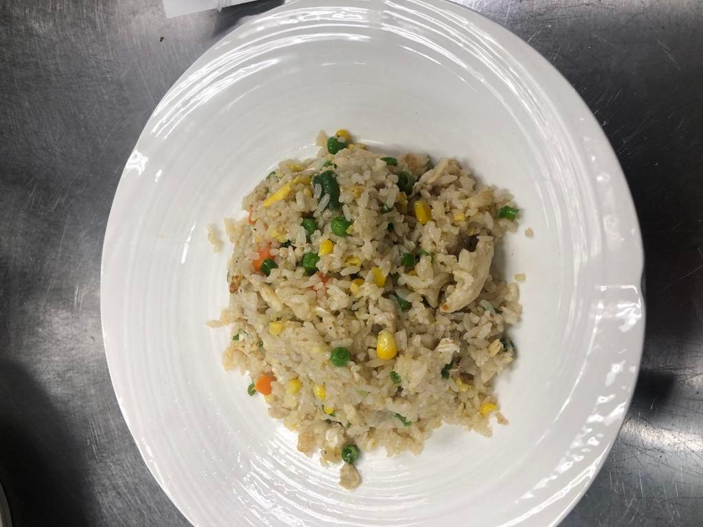 Chicken Fried Rice · Stir-fried rice with pieces of chicken, carrot, peas, and green onions.