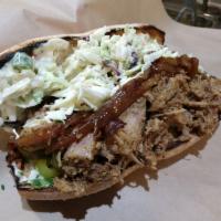 Roasted Adobo Pork Sandwich · Citrus marinated pork shoulder, caramelized onion, romaine, pickled charred serrano, cilantr...