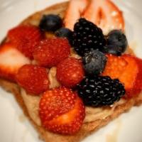 Peanut Butter Mascarpone and Berries Toast · Seasonal berries sweet peanut butter mascarpone cheese and drizzled with honey on toasted wh...