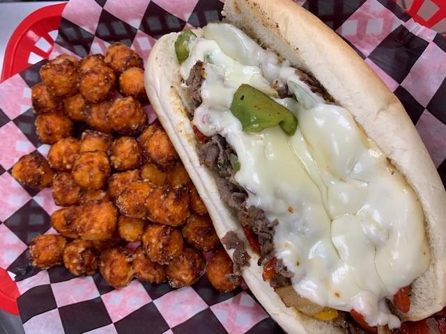 Philly Cheese Sandwich · Chopped sirloin or seasoned chicken breast sauted and grilled with onions and peppers with melted provolone cheese on sub roll. 
