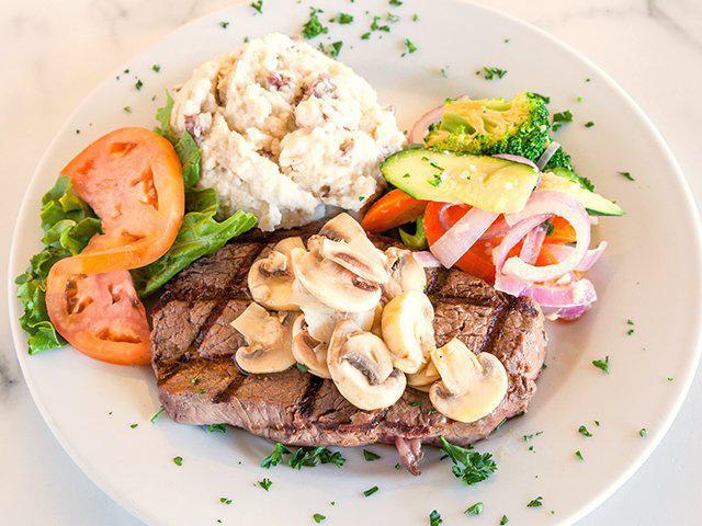 Top Sirloin Steak · A center cut 10 oz. top sirloin steak seasoned and grilled, topped with a rich Washington forest mushroom demi-glace. Served with sauteed seasonal vegetables and choice of side.