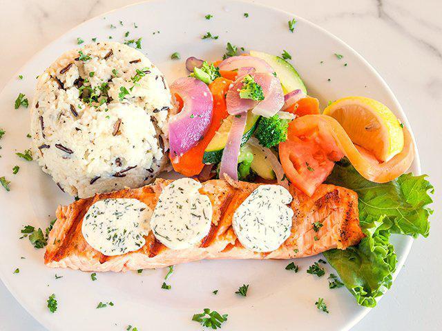 Wild Alaskan Salmon · Grilled wild Alaskan salmon and topped with tarragon herb butter. Served with choice of wild rice, garlic mashed potatoes, baked potato and vegetables.