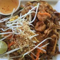 T18. Pad Thay · Thai style of rice noodle stir-fried with shrimp, chicken and egg. Topped with peanuts. Hot ...