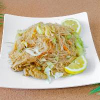 Pancit Bihon · Chicken noodle dish mixed with carrots and cabbage.