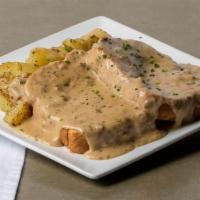 Eggs in a Hole · Two eggs cooked inside a piece of challah Texas toast, topped with creamy chipped beef gravy...