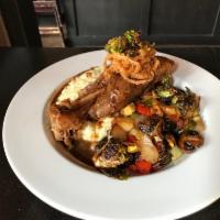 Slow Cooked Lamb Shank · Mixed veggies, pea risotto, crispy onions, and demi.