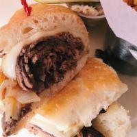French Dip Sandwich · Fresh baked roll with mounds of thinly sliced steak, melted provolone, grilled onion and a t...