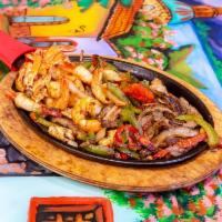 Fajita Mixta · Grilled shrimp, steak, chicken, red and green pepper onions, served with rice, beans and sal...