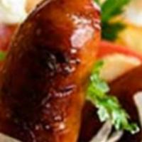 Loukaniko Pita · Greek sausage on a pita with lettuce tomatoes onions and sauce