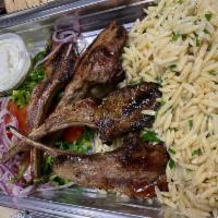 lamb chops · 5 tender baby lamb chops on the grill comes with tzatziki and choice of one side